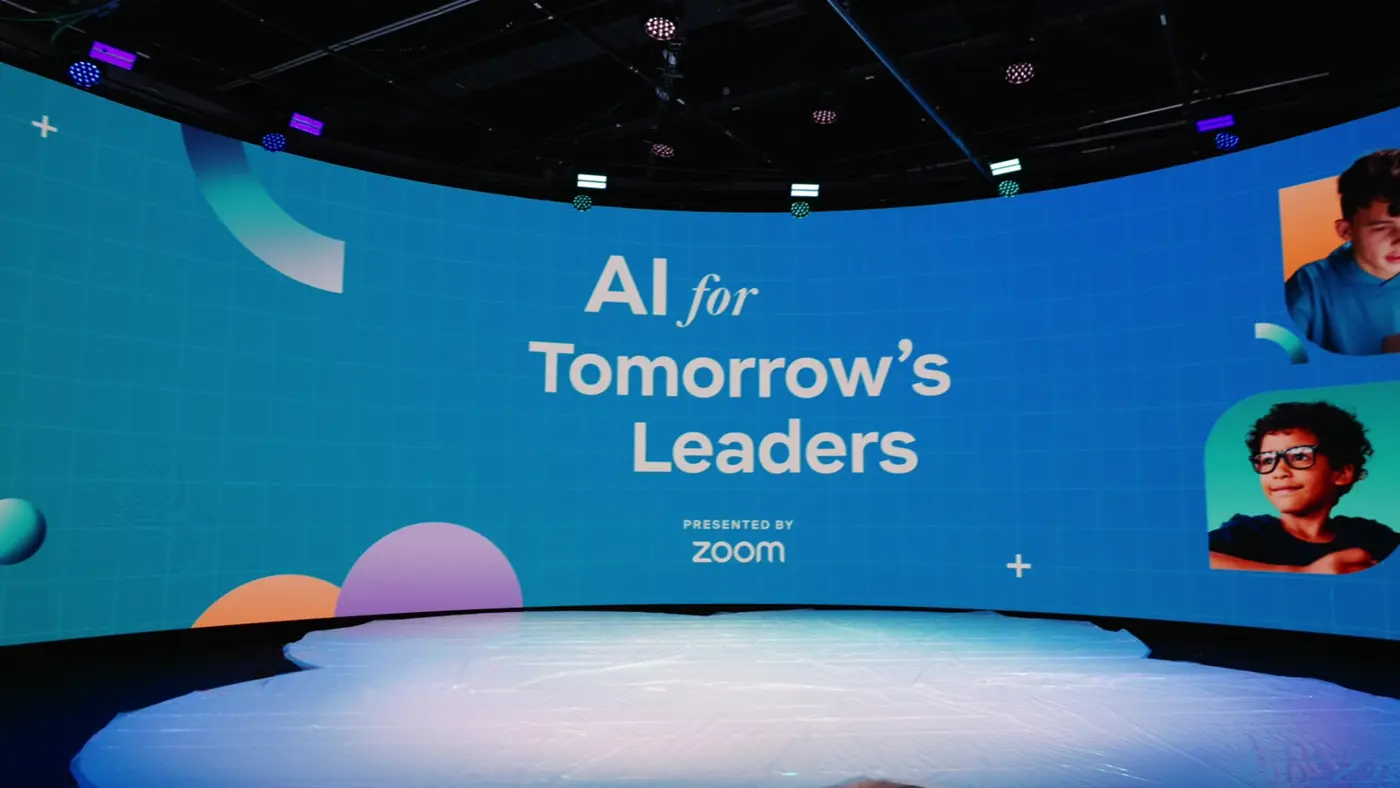 A curved LED stage branded AI for Tomorrow's Leaders