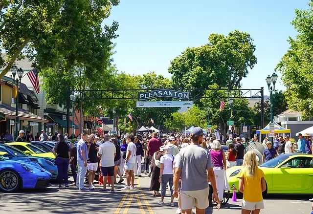 Crowds and Porsches on Main Street under the Pleasanton arch